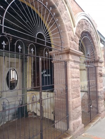 A gated brick building with arched entryways in Jerome Arizona