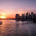 Bright orange sunset over Brooklyn Bridge and Manhattan