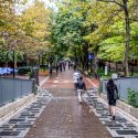 People walk along a tree-lined promenade in Philadelphia