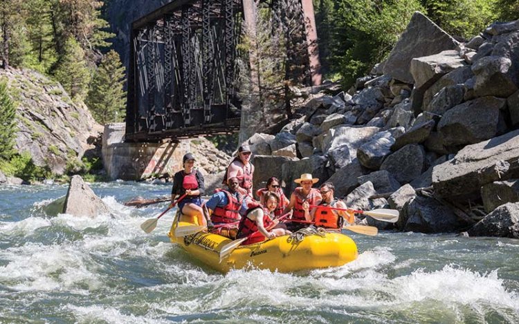 group of seven people whitewater rafting at Tamarack Resort.