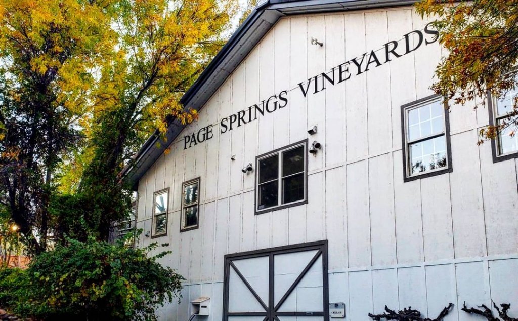 The black and white barn-face facade of Page Springs Vineyards in Cornville, Arizona.