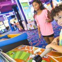A young boy and girl playing games in Arcade City in Table Rock Lake
