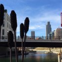 Bridge and building in Omaha, NE behind a red sculpture