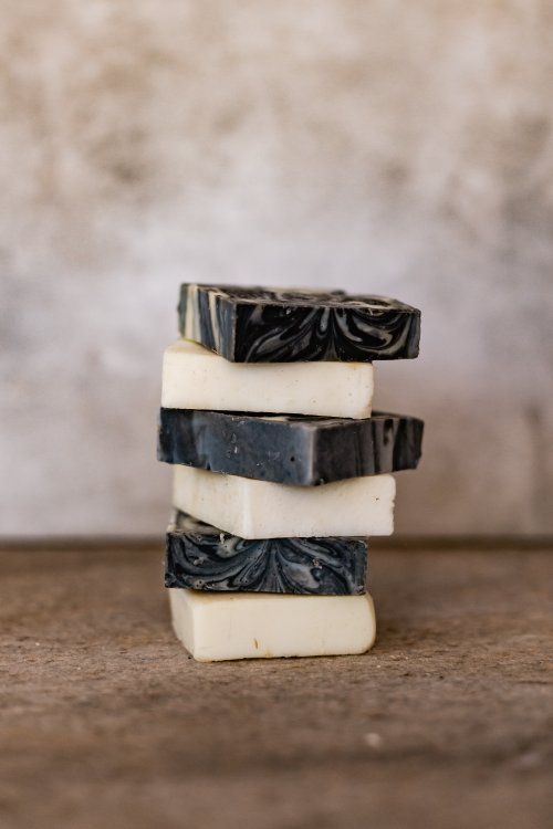 Bars of black and white soap stacked on each other